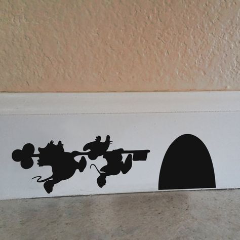 Check out these clever little illusion decals. These Disney Character Mouse Hole decals give the appearance of character shadows running to a mouse hole. These cute Disney Character Mouse Hole decals are made from a matte vinyl, to look like they’ve been painted on your walls. They easily come up, so there’s no mess or repainting necessary. … Minnie Mouse House, Casa Disney, Deco Disney, Cinderella Mice, Disney Room Decor, Disney Bedrooms, Mouse Hole, Tema Disney, Disney Rooms