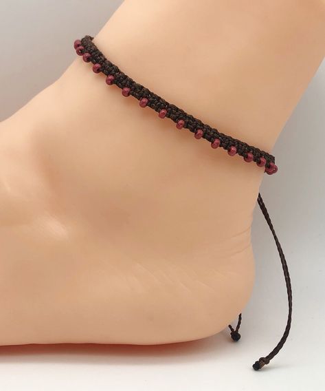 A handmade ankle bracelet made with a fine waxed waterproof cord and threaded with 3mm Preciosa seed beads.  The anklet fastens with a sliding woven knot making it fully adjustable. Cord Colour:  Brown Bead Colour:  Terra Intensive Red Brown Anklets are made to measure approximately 21/22cm but the adjustment knot and threads allow them to open wider if required. Kindly note, the photo is not to scale, please refer to the measurements above. As each item is individually handcrafted measurements are approximate. To prolong the life of this anklet please avoid contact with liquid, creams and perfumes. Wipe after wearing and store away in a closed container to avoid tarnish/fading. Handmade Ankle Bracelets, Festival Jewellery, Beaded Ankle Bracelets, Beaded Ankle, Beaded Anklet, Festival Jewelry, Beaded Anklets, Boho Bracelet, Ankle Bracelet