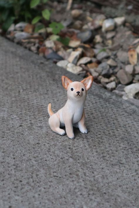 A miniature Chihuahua made from clay, photographed outside on stone paving. It is sitting up with a slightly concerned, wide-eyed expression. Miniature Chihuahua, Clay Dog, Dog Pottery, Clay Birds, Instagram Drawing, Wood Carving Patterns, Dog Sculpture, Wood Burning Art, Clay Animals