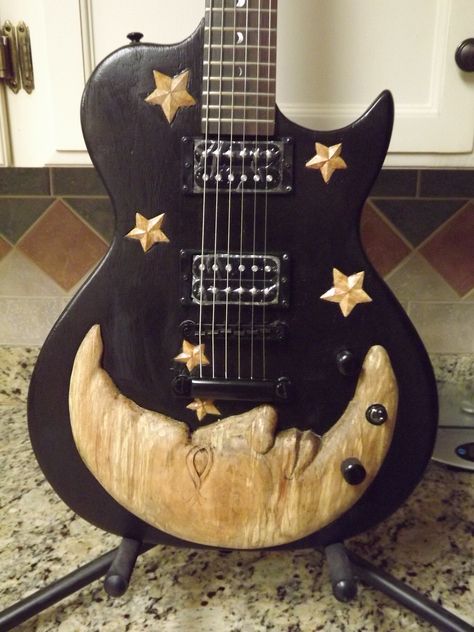 Luna Guitar I carved with a moon and stars motif Cool Ukulele Designs, Painted Guitar Picks Diy, Pretty Electric Guitar, Painted Guitars Ideas, Guitar Decor Ideas, Art On Guitar, Cool Guitar Designs, Aesthetic Instruments, Pickguard Art