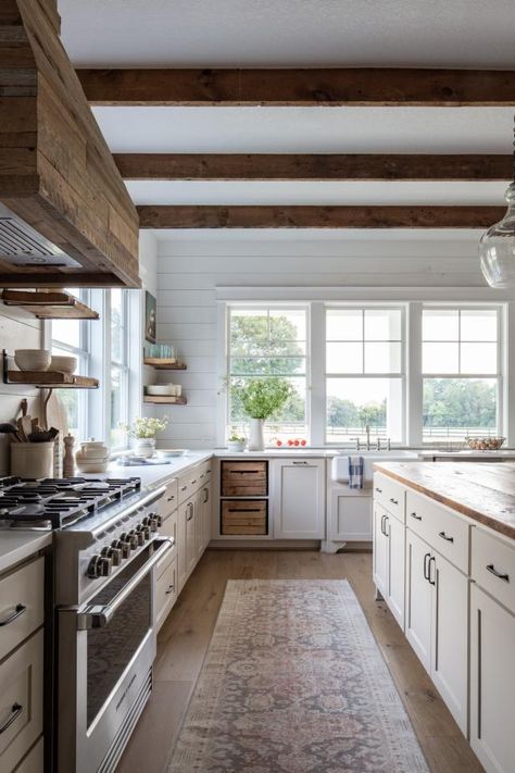 If your house is builder-basic, consider applying a little eye candy. New crown moldings, baseboards or shiplap paneling on the walls can give a space its own rich personality. For instant character, apply reclaimed wood to things like range hoods, islands and exposed beams. When breaking away from builder grade, it's all in the details. Traditional Farmhouse Kitchen, Italian Farmhouse, Moore House, Farmhouse Kitchens, Farmhouse Kitchen Ideas, Modern Farmhouse Kitchen, Cabin Kitchens, Farmhouse Kitchen Design, Rustic Farmhouse Kitchen