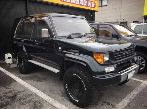 This black on black JDM lifted Toyota Land Cruiser Prado 78 has been outfitted with a set of massive 33x12.5 inch BF Goodrich A/T off-road tires and 15 inch rims with a period-correct design. Black window tint and wheels perfectly match with the exterior color. Land Cruiser 70 Series Modified, Trucks Modified, Toyota Tacoma Prerunner, New Toyota Land Cruiser, Land Cruiser 70 Series, Toyota Suv, Tacoma Truck, Classic Ford Broncos, Black Window