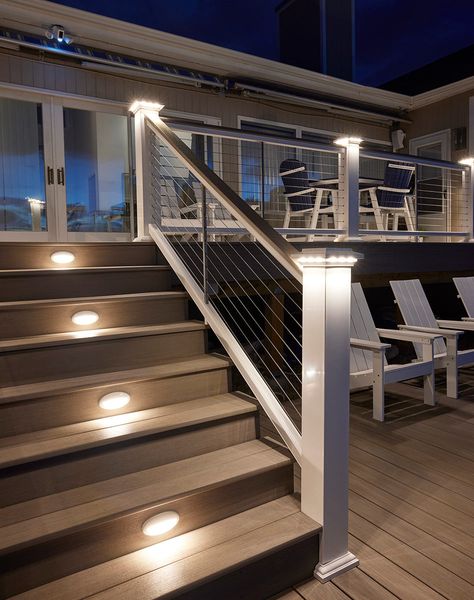 Add a soft, subtle glow to your deck with lighted island caps. Perfect for creating evening ambience. Easy on the Eyes Lights shine downward for a delicate radiance. A Subtle Glow Creates a slightly softer effect than a Post Cap Light. A Perfect Fit Fits beautifully with 5.5” post sleeves and post caps. Beautifully Integrated Designed to seamlessly coordinate with TimberTech Riser Lights, Under-Rail Lights, and Accent Lights. Low-Voltage Wiring 12 volts AC Raised Decks Backyard, Deck Post Cap Lights, Front Porch Post And Railing Ideas, Deck Stair Lighting Ideas, Deck On Side Of House, Back Steps To House, Timbertech Railing, Front Step Railing Ideas, Under Deck Skirting Ideas