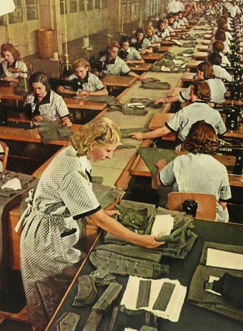 two long rows of women working at sewing machines, sewing gray uniforms Industrial Revolution Fashion, Made In Dagenham, Blouse Nylon, Generation Gap, Sewing Factory, Textile Factory, German Uniforms, Hometown Heroes, Berlin Fashion