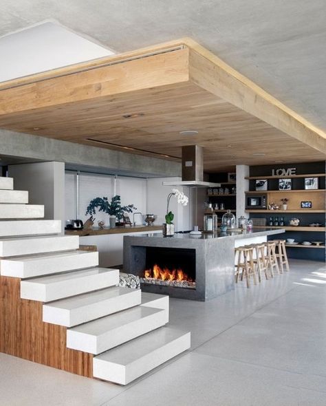 Modern kitchen island with fireplace, open stairs and XL overhang. Interesting design. Wood Benches, Modern Kitchen Island, Hus Inspiration, Design Exterior, Industrial Loft, Design Del Prodotto, Unique Kitchen, Hem Design, Ultra Modern