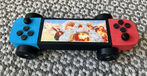 Nintendo switch pinewood derby car Pine Wood Derby Cars Designs Cub Scouts, Pokemon Derby Car, Awana Grand Prix Car Ideas For Boys, Cub Scout Derby Car Ideas, Barbie Pinewood Derby Car, Girls Pinewood Derby Cars, Pine Car Derby Ideas Design, Awana Car Designs, Pine Derby Cars Ideas Design