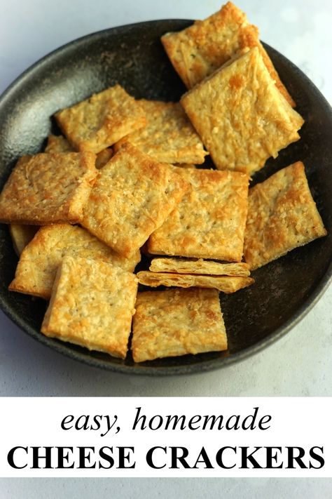 A dark coloured, shallow bowl filled with square shaped cheese crackers. One of the crackers had been snapped in half to show the flaky layers inside. Savoury Biscuits For Cheese, Cheese Cracker Recipes Homemade, Savoury Crackers Recipe, Cheddar Crackers Homemade, Cracker Recipes Homemade, Homemade Butter Crackers, Cheese Crackers Homemade, Rosemary Crackers Recipe, Pork And Apple Sauce