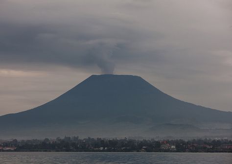 Nyiragongo contained a lava lake in its deep summit crater that was active for half a century before draining catastrophically through its outer flanks in 1977. The extremely fluid 1977 lava flows caused many fatalities, as did lava flows that inundated portions of the major city of Goma in January 2002. © Eric Lafforgue  www.ericlafforgue.com Nyiragongo Volcano, Eric Lafforgue, Lava Flow, Volcano, Mount Rainier, Lake, Natural Landmarks, Quick Saves