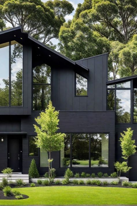 Modern black house with large windows, surrounded by lush greenery and trees. Tiny Modern House Exterior, Dark House Landscaping, Charcoal Home Exterior, Black And Wood House Exterior, Black Contemporary House, Black Exterior House, Black House Aesthetic, All Black House Exterior, Black Modern Home