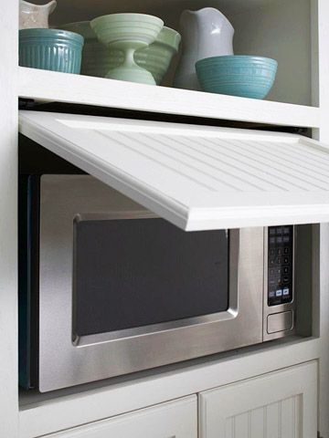 Move the Microwave Behind Closed Doors        Give your kitchen a cleaner look by concealing the microwave. This microwave fits into a cubby, and a slide-back door makes it easily accessible without taking up a single inch of counter space. Hidden Microwave, Fresh Kitchen, Kitchen Redo, Kitchen Remodel Idea, Traditional Kitchen, Kitchen Makeover, Kitchen Pantry, Küchen Design, Kitchen Stuff