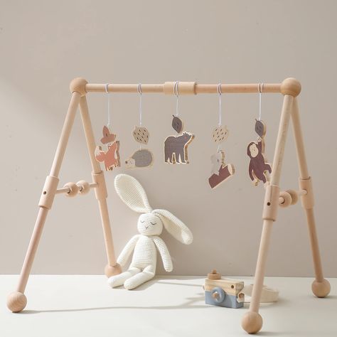 PRICES MAY VARY. 🦓【Excellent Design】: The wooden gym frame is made of unfinished beech, sanded to be smooth. Free of any chemicals. wooden baby gym comes with 5 wooden toys, including Bear, hedgehog, koala, fox, orangutan,5 Cute pendant + 1* Natural Wooden Baby Play Gym.It's child safe and saliva resistant! It’s great for teaching your baby to grab, crawl, sit up, stand up and go for the first steps. 🦁【Natural and Healthy】The baby gym retains the natural color of the wood, and the toys has a m Baby Hanging Toys, Wooden Play Gym, Baby Souvenir, Wooden Baby Gym, Baby Gym Toys, Baby Play Gym, Activity Gym, Play Gym, Hanging Bar