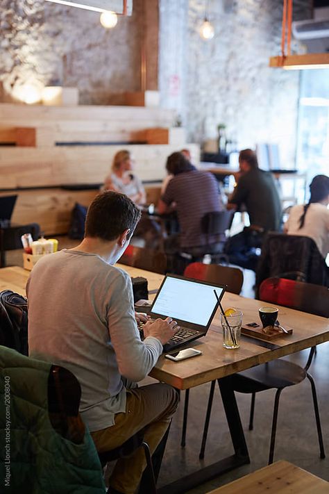 Stock photo of Young businessman working with computer and phone in a cafeteria by EstudiM6 Work Men Aesthetic, Work In Coffee Shop, Work Space Cafe, People At Coffee Shop, Work At Coffee Shop, Work From Coffee Shop, Cafe With People, People At Cafe, Work In Cafe