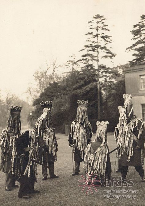 North Waltham Mummers, Hampshire, c. 1949 (Photographer: Douglas Dickins). Mummers’ Plays are a form of traditional drama, usually performed in the streets with a small but varied cast including St. George, the Turk, a doctor, and sometimes Santa Claus. Most mummers’ plays feature a combat scene in which a combatant is wounded or killed and then miraculously revived by the doctor. The costume varies from region to region, but those in Hampshire are known for their “tattered” jackets. Traditional Song, Pagan Rituals, The Turk, Folk Dance, New Museum, Traditional English, Folk Costume, Wonderful World, Woodland Creatures