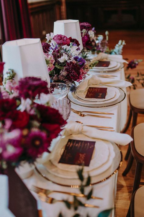 Burgundy, red, purple and pink wedding table decor with floral centrepieces, coloured glassware and gold cutlery | Shot by Bek Burgundy And Purple Wedding Table Settings, Dark Purple And Pink Wedding Theme, Red Purple And Gold Wedding, Purple And Burgundy Wedding Decor, Plum Wedding Colors Colour Palettes, Plum And Burgundy Wedding, Burgundy And Purple Wedding, Sangria Wedding Colors, Purple And Burgundy Wedding