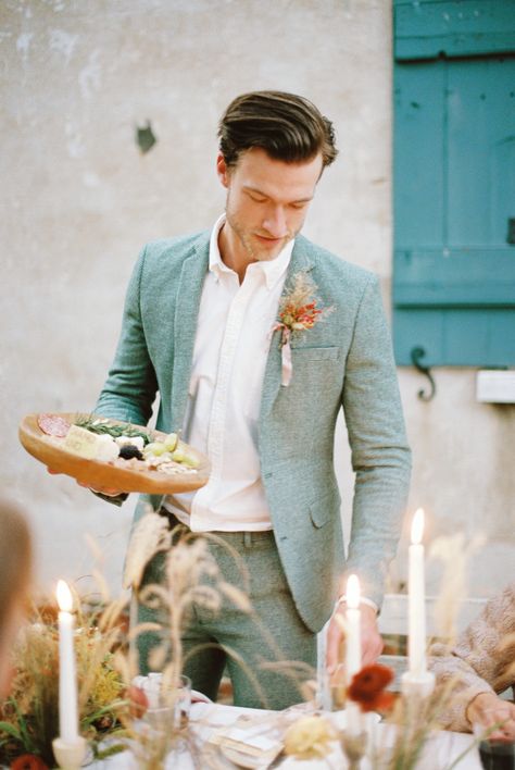 This runaway elopement with southern accents and an artisan feast is too much to handle! Alternative engagement rings, daring color combos and a silky apricot gown are just a few of the eye-popping details you can expect to see in this autumn inspiration on #ruffledblog! Sage Suit Men Wedding, Colored Suit Groom, Groom Suit Italian Wedding, Sage Suit Groom, Cool Wedding Suits For Men, Groom Suit Alternative, Groom Alternative Outfit, Alternative Wedding Suits Men, Summer Groom Suit Ideas