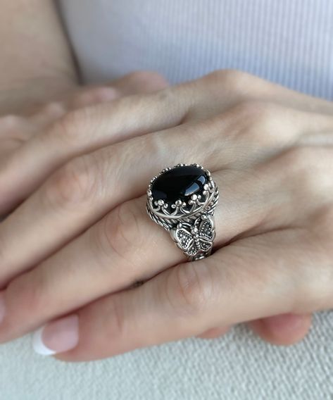 🦋✨ Transform your look with the elegance of nature! Our exquisite 925 Sterling Silver Filigree Butterfly Cocktail Ring is a true masterpiece, featuring intricate details and the captivating allure of Black Onyx - a gemstone fit for January babies and beyond! 🖤 Ready to make a statement? Flutter over to our #EtsyShop and let your style soar. Click to discover or indulge: https://nuel.ink/BQpy5P #SterlingSilver #BirthstoneBling #ButterflyJewelry #HandmadeLuxury Silver Rings With Black Stones, Onyx Stone Ring, Black Onyx Rings Women, Black Stone Ring Women, Butterfly Cocktail, Black Gemstone Ring, Stone Ring Design, Jewelry Rings Unique, Black Jewellery