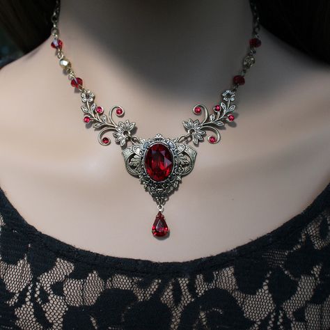 "This vintage medieval styled crystal necklace features luscious Scarlet colored Swarovski crystals with nice crisp facets and brass embellishments.  Rich with elegance, this piece would be perfect for a moonlit date night, medieval fair and countless formal events. The necklace focal point, along with the drop crystal, measures approximately 2\" long and 1-1/2\" wide. The brass chain is 18\" long and can be shortened by hooking the lobster clasp onto any of the 4x6mm cable chain links for a customized fit.  If you need a longer chain then please let me know!  I can add a 2\" extension. The vintage styled earrings - sold separately- perfectly compliment the necklace and also feature lush Austrian Scarlet crystals and brass base metal. The crystal settings are 14k gold plated. The lever bac Vampire Jewelry Necklaces, Necklace Vampire, Medieval Necklace, Vampire Necklace, Vampire Jewelry, Medieval Fair, Red Crystal Necklace, Gothic Medieval, Earrings Gothic