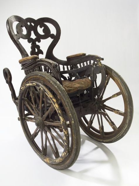 Invalid chair, Europe, 1850-1890: Unlike modern wheelchairs that have four wheels, this chair has three: two large front wheels and one small rear wheel. This means the patient was unable to wheel the chair themselves. They would have had an assistant. The chair is heavy so presumably they would not have gone very far or very fast. This elaborately carved chair dates from the late 1800s. It is made of wood with a sprung padded seat. It was donated to the Wellcome Collec Wellcome Collection, Vintage Medical, The Patient, The Infernal Devices, Wheelchair, Victorian Era, Old Fashioned, Vintage Antiques, Dates