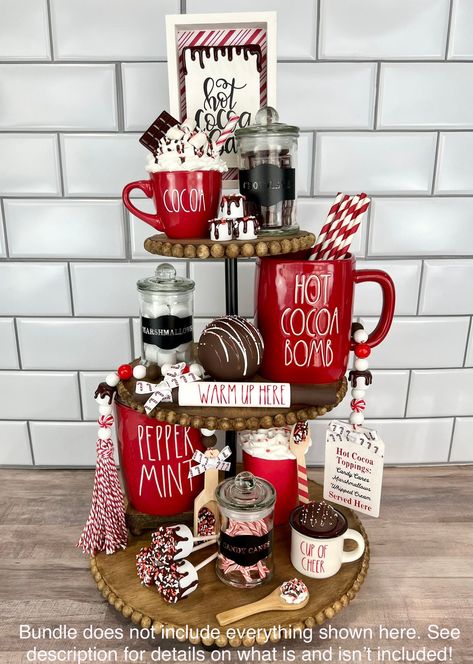 "This listing is for the Hot Cocoa Bar Bundle and includes: -Mini Red \"Cocoa\" Mug with mini wooden spoon (mug-top tier, spoon-bottom tier) -Hot Cocoa Bar sign (top tier, back center-may need small risers to make taller as shown in photos) -Set of 3 Empty Glass Jars (Marshmallows, Chocolate, Candy Canes- one on each tier-hand wash only-made with permanent vinyl-contents not included-jars will come empty) -Wooden Spoon with set of 3 mini marshmallows (mallows on top tier, spoon on bottom tier) - Hot Cocoa Tiered Tray, Cocoa Tiered Tray, Christmas Hot Chocolate Bar, Canes Decor, Coffee Bar Station, Tray Decor Christmas, Faux Food, Tiered Tray Diy, Dessert Candles