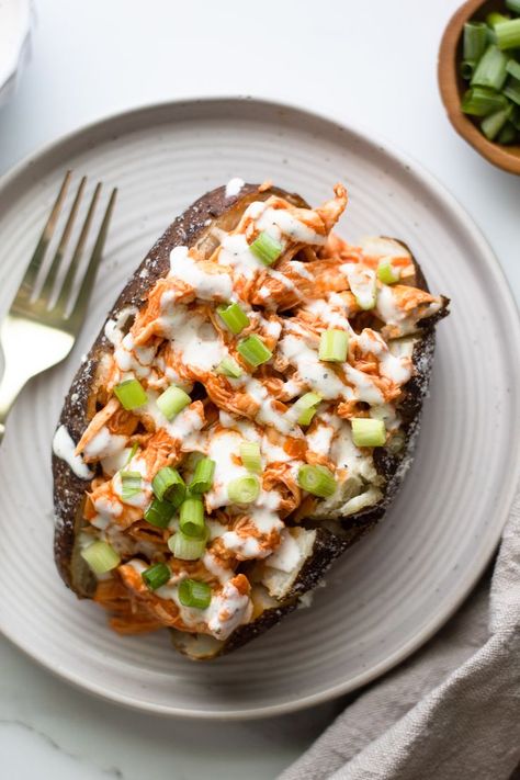 garnished buffalo chicken baked potato on a plate Buffalo Ranch Chicken, Shredded Buffalo Chicken, Chicken Potato Bake, Paleo Slow Cooker, Baked Buffalo Chicken, Stuffed Sweet Potatoes, Healthy Buffalo Chicken, Chicken Stuffed, Chicken Sweet Potato