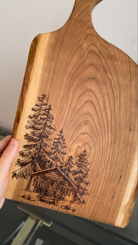 Wood Burned Mountain Scene, Wood Burning Bread Board, Charcuterie Board Burn Design, Wood Burning Memorial Ideas, Wood Burn Furniture, Burned Wood Design, Rustic Wood Burning Ideas, Woodburned Charcuterie Board, Mountains Wood Burning