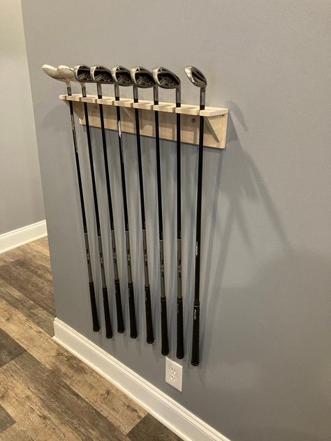 24 Inch Display with 8 Club Capacity Mounts to the wall, can be close to the ceiling to save space. Made out of solid Poplar Wood, ready to be stained or painted. Designed for standard size shaft and hosel. NOT THICK SHAFTS Designed and Handcrafted by Rick Horne the inventor of the Halo Golf Ball Pick Up Golf Club Wall Display, Golf Diy Projects, Golf Club Display, Golf Bedroom, Golf Furniture, Hickory Golf, Office Golf, Golf Simulator Room, Golf Ball Displays