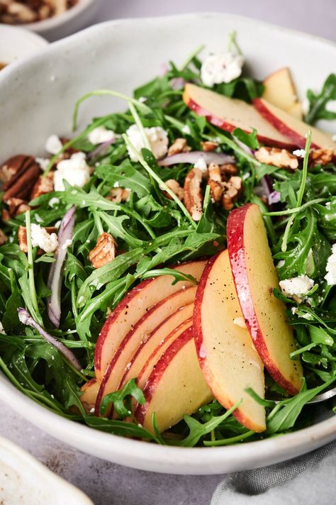 Looking for a fun and delicious salad to serve? This arugula, goat cheese, and apple salad with a lemon vinaigrette is the perfect side salad or main dish. #appetizer #salad #sidedish #quickandeasy Salad To Serve With Pasta, Arugula Salad With Feta Cheese, Arugula Apple Salad Recipes, Arugula Salad Recipes Goat Cheese, Arugula Salad Apple, Recipe With Arugula, Elegant Lunch Ideas, Arugula Recipes Salad, Apple Cheese Salad