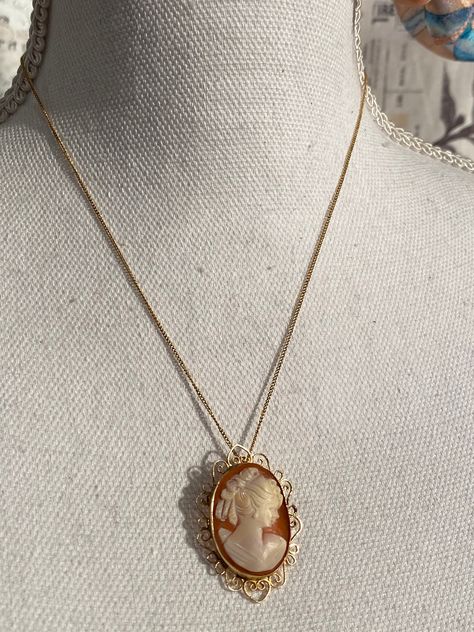 Estate Fresh ! This is a beautiful and elegant 12k Fill Cameo Pendant Brooch Necklace. 12k Chain is stamped on Novelty Vintage Clasp and Cameo is stamped on back inside setting. She is a right facing Victorian Lady Hand Carved From Shell. The Gold setting has a dainty border which makes a heart at the top and bottom. She is cold to the touch has has the curve of the Shell. This is a vintage estate item therefore they may show some wear or imperfections adding to the character & authenticity. Cameo Necklace Aesthetic, Antique Cameo Jewelry, Scorpio Necklace, Rhinestone Jewelry Set, Pendant Brooch, Cameo Jewelry, Victorian Lady, Vintage Cameo, Brooch Necklace