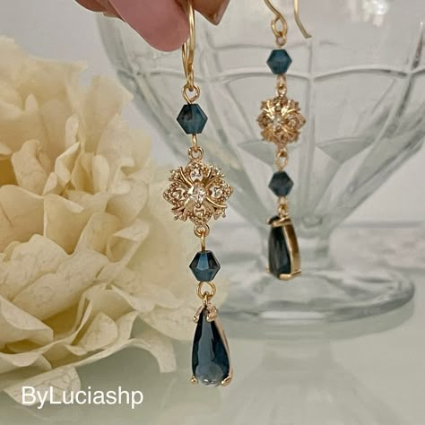 Elevate your elegance with our gold-plated Art Deco earrings: a combination of timeless sophistication and contemporary charm. The navy blue teardrop-shaped crystals hang gracefully, creating a fascinating play of light that is sure to catch everyone's eye. Blue crystal bicones complete this wonderful look. Something Blue takes on a whole new meaning with these earrings, making them the perfect choice for brides looking to incorporate a touch of tradition and style. The earrings provide comfort Gold And Blue Earrings, Blue Earrings Aesthetic, Navy Earrings, Shaped Crystals, Crystal Teardrop Earrings, Earrings Making, Deco Earrings, Blue Dangle Earrings, Etsy Bridesmaid Gifts