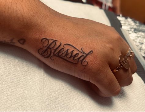 Blessed hand tattoo Blessed In Cursive Tattoo, Blessed Tattoo Cursive, Blessed Wrist Tattoo, Gonzalez Tattoo Name, Hand Word Tattoos For Women, Boy Hand Tattoos, Blessed Tattoo On Hand, Tattoo Ideas Blessed, Hand Tattoo Stencils For Men