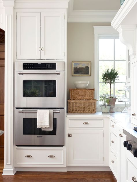 Typically stacked and built directly into perimeter cabinetry, double ovens provide a sleek look and added convenience. This kitchen feature offers a main oven you can use without bending over and a secondary oven for plate warming and additional baking. #kitchenideas #kitchenremodel #kitchenplanningideas #kitchenmakeover #bhg Wall Oven Kitchen, Outdoor Kitchen Countertops, Kitchen Decor Themes, Kitchen Designs Layout, Kitchen Design Trends, Kitchen Farmhouse, Smart Kitchen, Kitchen Trends, Trendy Kitchen