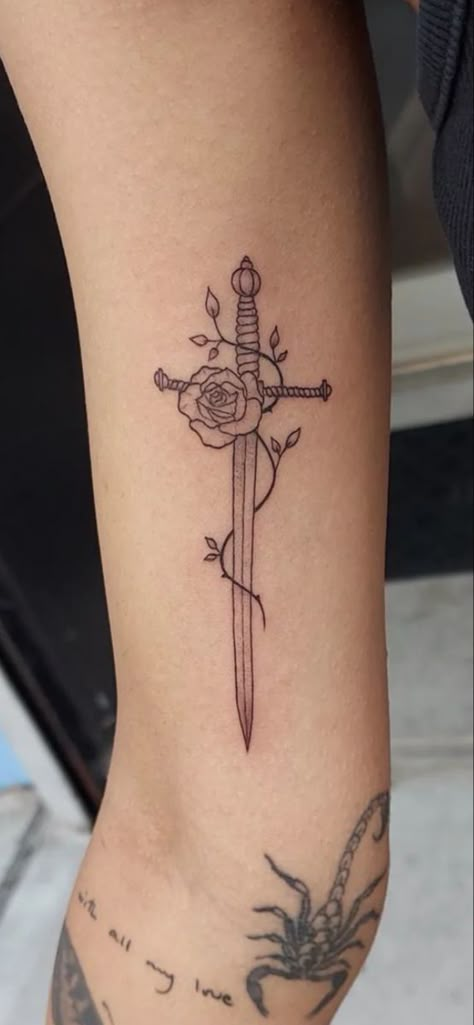 Rose With Swords Tattoo, Spine Dagger Tattoo, Girly Dagger Tattoo, Irish Rose Tattoo, Dager Tattoos For Women, Dagger And Flower Tattoo, Dagger Thigh Tattoo, Tiny Dagger Tattoo, Knife With Flowers Tattoo