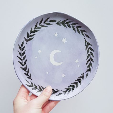 This moon and stars plate is handmade with love from ceramic, handpainted, glazed and fired in my tiny studio.  Made using food safe glazes. DIMENSIONS:  18 cm (7 in) in diameter Each one is one of a kind. Feel free to message me if you have any questions!   Are you looking for my pet portrait shop? It's HelloCloudy.etsy.com !  Follow me on social media: instagram: hellocloudy twitter: hellocloudy_art tiktok: hellocloudy_art Paint Ideas For Ceramics, Cloud Pottery Painting, Sun And Moon Pottery Painting, Pottery Painting Mandala, Celestial Pottery Painting Ideas, Witchy Pottery Painting, Easy Plate Painting Ideas, Moon Pottery Painting, Cute Plate Designs