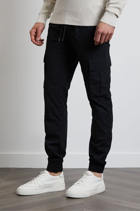 Freshen up your casual wardrobe with these slim fit, cuffed cargo trousers from Threadbare. They have an elasticated waist for comfort with fly fastening and drawcords. They feature four pockets and two cargo style pockets on the legs. Other colours available. Machine washable. 100% Cotton. Trousers Outfit Men, Black Trousers Casual, Mens Cargo Trousers, Mens Cuff, Black Cargo Pants, Men Trousers, Forward Thinking, Comfortable Style, Cotton Trousers