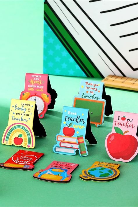 Celebrate your teacher's dedication with the perfect gift! This set of magnet bookmark clips, available in 10 charming styles, ensures you'll always have a reliable marker at hand. They slip into any book without effort. Adorned with delightful Teacher's Day motifs like books, clocks, and apples, they capture the essence of teaching. Suitable for students, professionals, and various settings, these magnetic bookmarks add a touch of practicality to every page-turning moment. Teachers Day Bookmark, Magnets With Cricut, Bookmarks For Teachers, Teachers Day Gift Ideas, Teacher Magnets, Magnet Bookmark, Teacher Bookmark, Message For Teacher, Expo Marker