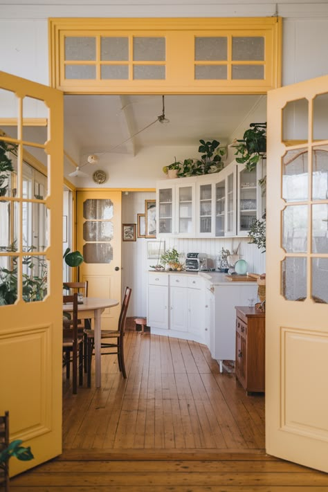 45 Interior Door Color Ideas You’ll Want To See Colored Entryway Door, Tan Painted Interior Doors, Glass Door To Bathroom, Painted Kitchen Door, Different Color Doors In Hallway, Colorful Hallway Doors, Yellow Interior Door, Colored Trim Interior, Painted Doorway