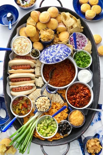 Chili Charcuterie Board for Game Day, Super Bowl, Award Shows or Winter Gatherings | HGTV Halloween Chili Charcuterie Board, Chili Condiment Bar, Halloween Chili Party, Chilli Charcuterie Board Ideas, Chili Bar Ideas Fall Party, Chilli Charcuterie Board, Chili Fixings Bar, Chilicuterie Board, Chili Boards