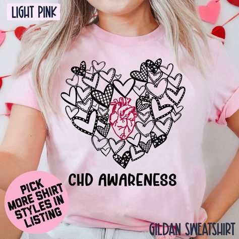 CHD Awareness T-shirt, Anatomical Heart Tee, Heart Disease Awareness Sweatshirt, Cardiology Hoodie, Heart Patient Gift, Red Ribbon Shirt **PLEASE NOTE: 1. Please check the color charts for the size and type of the shirt. We have many type of shirt such as Gildan Sweatshirt, Gildan Hoodie, Gildan T-shirt. If you want to change anything in order, please contact us right away. 2. Check carefully the shipping address before placing orders. If the customer gives us the incorrect shipping address that makes the package gets lost, WE WILL NOT send the replacement or refund.  *If you entered the wrong address, please contact us right away. Addresses CANNOT be changed once the order is shipped* --PRODUCT FEATURES-- * Luxurious Comfort: Made from 100% premium cotton, this shirt is soft, breathable, Chd Awareness, Awareness Shirts, Heart Defect, Gildan Sweatshirt, Ribbon Shirt, Heart Tee, Gildan Hoodie, Anatomical Heart, Band Shirt