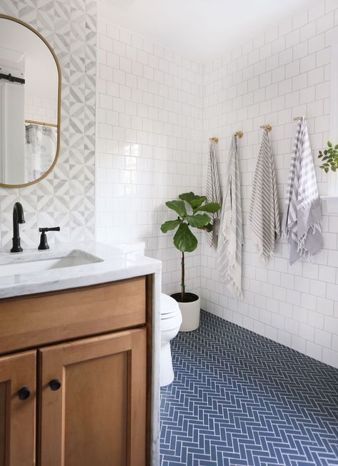 Modern Farmhouse Bathroom Renovation: Gorgeous wooden vanity with carrara marble countertop and mid century style knobs and pulls from Schoolhouse electric. This bathroom also features a blue herringbone tile floor and marble mosaic tile backsplash. Blue Herringbone Tile, Herringbone Tile Floors, Wooden Vanity, Modern Farmhouse Bathroom, Herringbone Tile, Boys Bathroom, Geometric Tiles, Blue Bathroom, Bathroom Floor Tiles