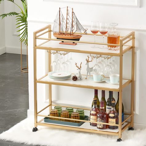 PRICES MAY VARY. Ample Storage Wine Cart: This cart features ecological multilayer board on the 3 shelves while a gleaming gold metal frame offers a great solid look and room for all the essentials. 2 sets stemware racks at the bottom of the middle shelf can hold around 12 glasses. Finding the right bar cart to suit your style has never been easier thanks to our wide range. Stylish-Chic Design: This entertaining bar cart is a beautiful, modern design boasting an elegant gold finish. An of-the-mo Wine Cart, Bar Serving Cart, Gold Bar Cart, Cart With Wheels, Serving Cart, Home Bar Furniture, White Office, 3 Shelves, Hospital Furniture