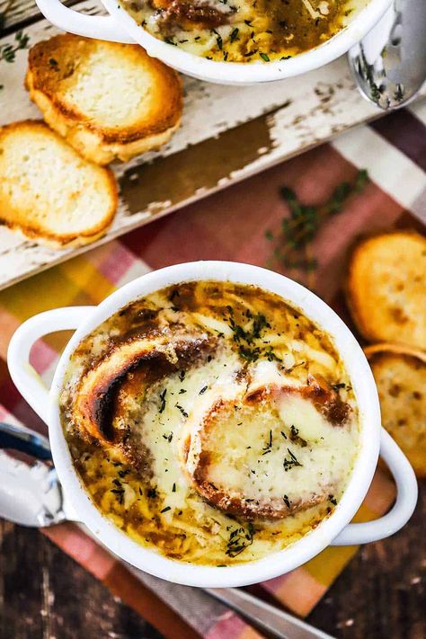 Two white bowls filled with French onion soup and topped with toasted bread slices and melted cheese. Recipe With Red Wine, Easy French Onion Soup, Homemade French Onion Soup, Red Wine Recipe, French Soup, Cozy Soup, French Onion Soup Recipe, Onion Soup Recipes, Toasted Bread