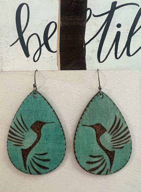 This is a pair of Handcrafted Woodburn 2.5" Hummingbird Earrings with weathered copper color wash tint. Nickel free ear wires.  Lightweight Wood Burning Earring Ideas, Wood Burning Earrings Diy, Laser Engraved Jewelry, Woodburned Gifts, Christian Boutique, Painted Bookmarks, Cross Bags, Cricut Earrings, Wood Jewelery