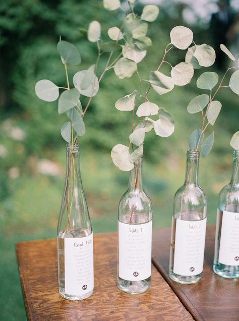 Wine Bottle Centerpieces: Glass Table Escort Display  with Greenery Wine Bottle Wedding Centerpieces, Wine Bottle Centerpieces, Wedding Wine Bottles, Wedding Motifs, Bottle Centerpieces, Wedding Champagne, Wedding Bottles, Unique Wedding Flowers, Wedding Floral Centerpieces