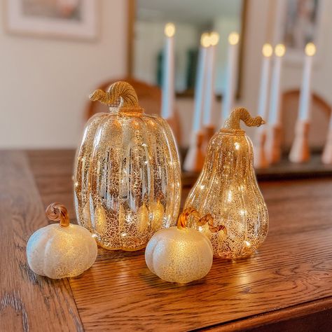 This set of 3 white glass pumpkins were created as a modern update for classic fall decoration. Each pumpkin emits a warm white light, with a single LED shining through the distinct mercury glass finishing. Great for indoor use in an autumn tablescape, mantle or console display. This battery operated set of three adds a festive glow to bookshelves, a dining sideboard, or next to the kitchen fruit basket. Perfect for an elegant Thanksgiving dinner party, adding a touch of glamor in a traditional Mercury Glass Pumpkins, Dinner Tablescape, Thanksgiving Dinner Table Decorations, Console Display, Christmas Dining Table Decor, Indoor Lanterns, Dining Sideboard, Fall Room Decor, Fall Bedroom Decor