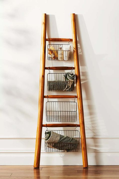 Decorative ladder with wire bins hanging from rungs Interior Ladder Decor, Ladder In Bathroom Decor, Ladder To Hang Plants, Wide Blanket Ladder, Ladder Room Decor, Wooden Ladder Decor Living Room, Styling Blanket Ladders, Townhome Entryway Decor, Ladder In Kitchen