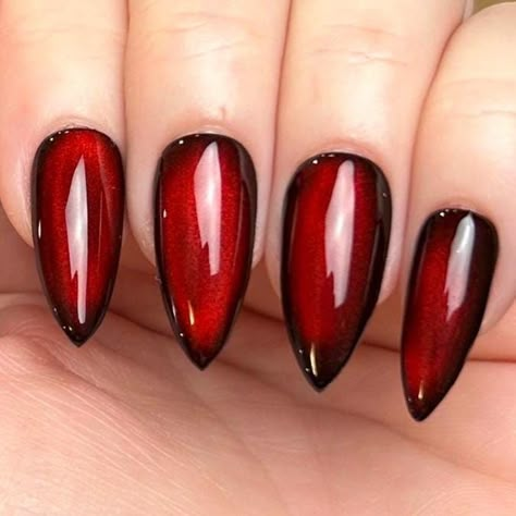 Pictured in medium stiletto and medium square.  Black Apres Gel X press-on nails with silver reflective cat eye topped with blood red jelly color gel. Looks completely black until the light hits just right, revealing a striking blood-red hue, almost appearing as if it's lit from within. Please note: colors and shine will vary depending on photography, lighting and angles. --MATERIALS AND CRAFTSMANSHIP-- This set is crafted with meticulous care using high-quality UV gel materials, including Après Black Cherry Cat Eye Nails, Red Cat Eye Gel Nails, Black Red Cat Eye Nails, Red Reflective Nails, Blood Red Cat Eye Nails, Red Black Chrome Nails, Red And Black Cat Eye Nails, Moulin Rouge Nails, Red Moon Nails