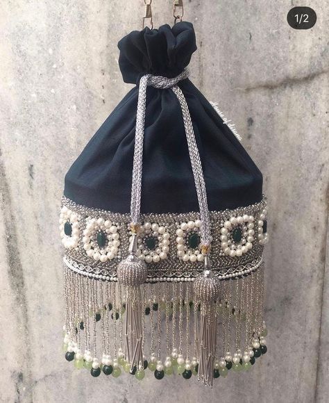 This is a beautiful handcrafted potli bag made with love.It has intricate handwork which showcases the Indian craftsmanship by our local artisans. It comes with a matching pearl handle. Details  - Both side handwork  - Fabric lining on the inside to keep your belongings safe  - Metal lock closure  - Golden metal knob - Detachable handle This clutch can be worn as a crossbody bag or a shoulder bag with the sling chain or can simply be carried in hand.It is spacious enough to carry mobile phones, Aari Work Potli Bag, Handmade Potli Bags, Potali Beg Design Indian, Pearls Bag, Cuffs Diy, Potli Bag, Hand Embroidery Tutorial, Potli Bags, Pearl Bag