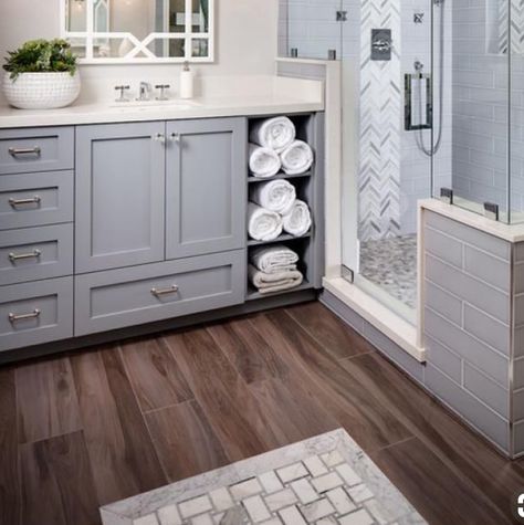 Kids bathroom vanity in grey with wood tile floor, marble tub surround Grey Vanity Wood Floor Bathroom, Bathroom Ideas With Dark Wood Floors, Gray Tile Bathroom Floor Wood Vanity, Light Grey Vanity Bathroom Ideas, Gray And Brown Bathroom Ideas, Wood Tile Bathtub, Wood Tile Floor Bathroom, Maine Bathroom, Tile Floor Bathroom