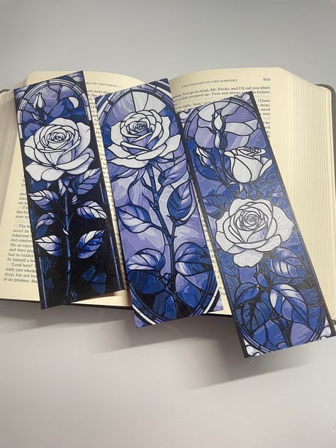 Introducing our exquisite Stained Glass Rose Bookmark Pack of 3 - a collection that merges the beauty of stained glass art with the timeless elegance of roses. Elevate your reading experience with these stunning bookmarks, each crafted to add a touch of sophistication to your favorite books. 🌹 Immerse yourself in the enchanting world of literature with our Stained Glass Rose Bookmarks. Each bookmark features a meticulously designed rose in the style of stained glass, creating a visual masterpiece that captures the essence of both art and nature. 📚 This pack includes three distinct bookmarks, allowing you to infuse your reading routine with the captivating charm of stained glass roses. Let these bookmarks grace the pages of your novels, journals, or poetry collections, marking your place Cool Bookmark Designs, Stained Glass Bookmark, Bookmark Shapes, Artistic Bookmarks, Aesthetic Bookmark Ideas, Book Mark Designs, Bookmark Design Ideas, Book Mark Ideas, Bookish Crafts