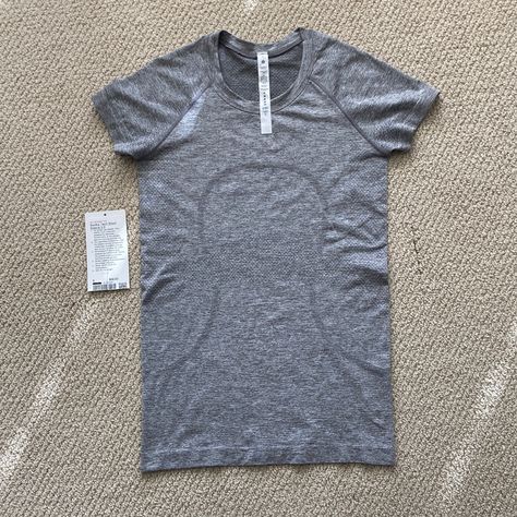 Bundle This Item With Any Of My Other Items To Save! If You’re New To Poshmark And Creating Your Account, Use My Discount Code, Pm_lululemon, To Receive $10 Off! Lululemon Swiftly Tech Short Sleeve 2.0 Crew Shirt Size 6 Slate White Nwot Brand New Without Tags Condition Lululemon Swiftly Tech Short Sleeve Crew 2.0 In The Color Slate / White (A Grey Color) Size 6 - Equates Roughly To A Size Small Measurements Are Flat Lay Approximate: Pit To Pit 15.25” Roughly And Stretches An Additional 1.5” Leng Lululemon Grey Shirt, Black Lululemon Shirt, Lululemon T Shirt, Grey Swiftly Tech Outfit, Lululemon Shirts & Tops, Grey Lululemon Shirt, Lulu Tops, Lulu Shirt, Lululemon Swiftly Tech Short Sleeve